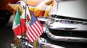 The Mexico, United States and California flags are positioned on the front grill of a lowrider, May 27, 2022.