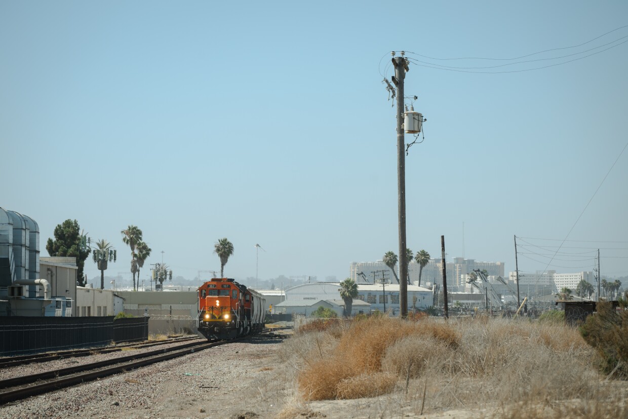 A freight train passes next to the site of the proposed USD Fuels transfer station sits empty in National City, California on July 10, 2025.