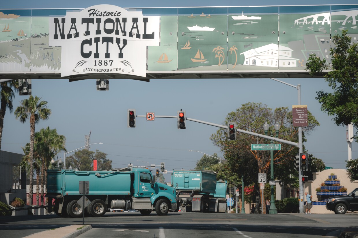 Heavy trucks rumble through downtown National City, California on June 17, 2025.