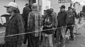 Homeless migrants stand in line for breakfast at Tijuana migrant shelter Desayunador Salesiano, March 23, 2017.