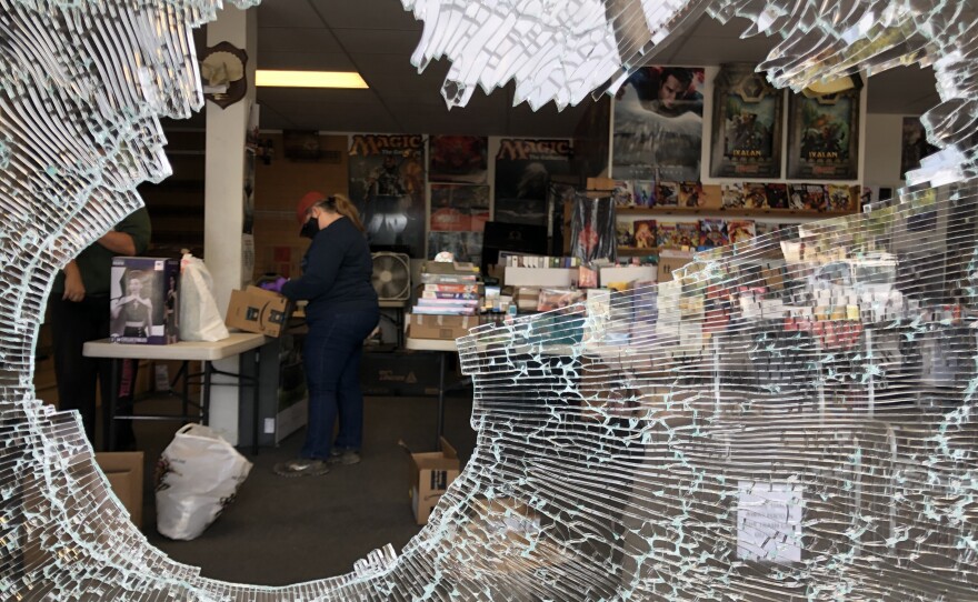 A hole in the window of a comic book store in La Mesa following a night of protests, May 31, 2020.
