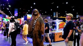 A Chewbacca cosplayer oversees the convention floor on Thursday. July 20, 2023.